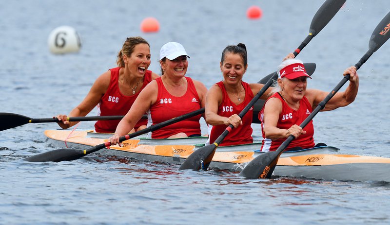 Four Masters Women laughing and having fun after a regatta race in a K4